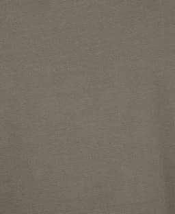 A textured green fabric, close-up, suitable for a polo shirt design. It features a branding logo.