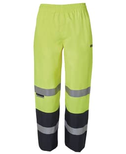 High-visibility rain pants in bright yellow with black lower sections and reflective grey stripes, featuring a logo.
