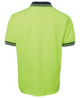 A bright green polo shirt with a navy collar and striped detailing. The shirt has a branding logo.