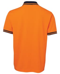An orange polo shirt featuring a navy collar and striped cuffs, with a logo on the side.