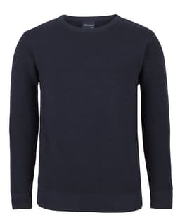 A navy blue knitted crew neck jumper with ribbed texture and long sleeves. It features a logo on the inner neck.