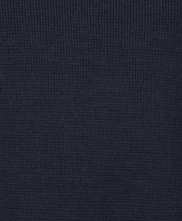 A navy blue chunky knitted jumper featuring ribbed texture and a crew neck design. It includes a logo.