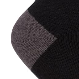 A close-up of a black sock with a grey toe and heel, featuring a logo.