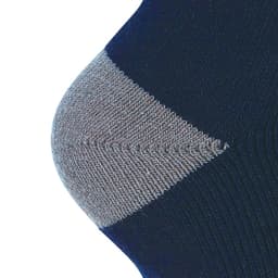 A close-up of a dark blue sock with a grey ribbed cuff, featuring a logo.