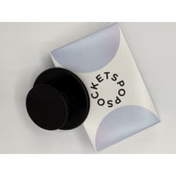 A black PopSocket MagSage on a light pastel background, featuring a circular design with branding.