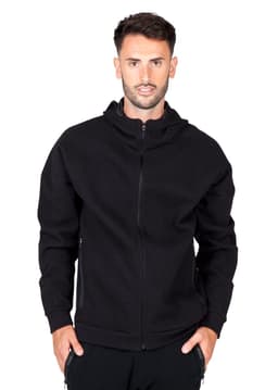A black hoodie with a front zip and a hood, featuring a logo on one side. The model is wearing it.
