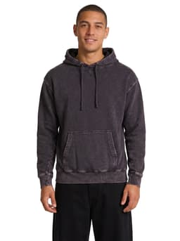 A dark stone wash fleece hoodie with a front pouch pocket and a drawstring hood, worn by a smiling model.