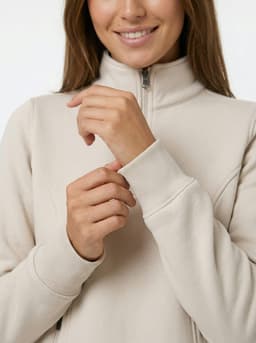 A woman in a grey half zip fleece and a man in a navy half zip fleece, both standing outdoors.