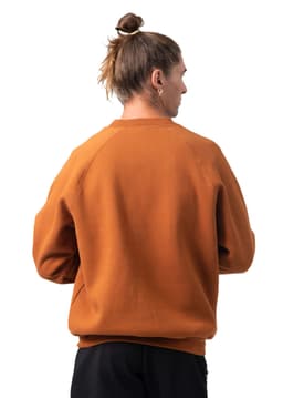An adults' cotton care sweatshirt in a warm orange colour, featuring a simple design and a logo on the front.