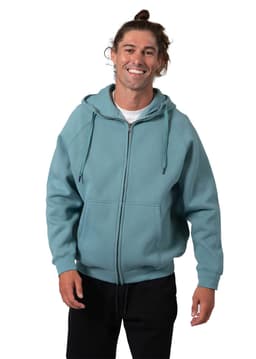 A man wearing a blue-green zip-up hoodie with a kangaroo pocket, smiling and standing against a white background.