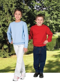Two children stand outdoors wearing jumpers; one in light blue and the other in red, both with branding.