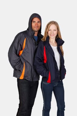 A grey and navy nylon rain jacket with orange and red accents, featuring a hood. Includes a logo.