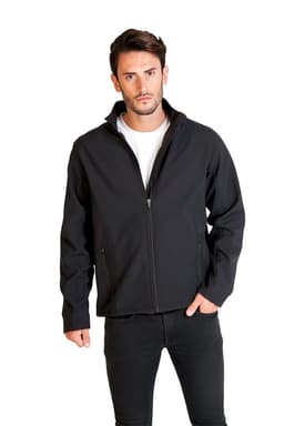 A black soft shell jacket is worn by a man standing with his hands in pockets, showcasing a sleek design.