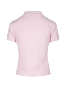 A light pink women's cotton polo shirt with a collar and rolled sleeves. Features a logo on the back.