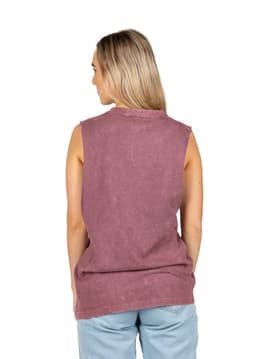 A woman wearing a stone washed purple tank top, featuring a relaxed fit and sleeveless design.