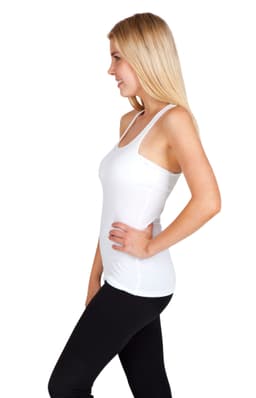 A woman wearing a white T-back singlet paired with black leggings, smiling at the camera. The singlet features a logo.