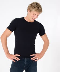 A fitted black spandex T-shirt on a model, featuring a logo on the sleeve.