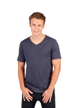 A man models a dark blue, unisex raw cotton V-neck T-shirt. The shirt features short sleeves and a fitted style.