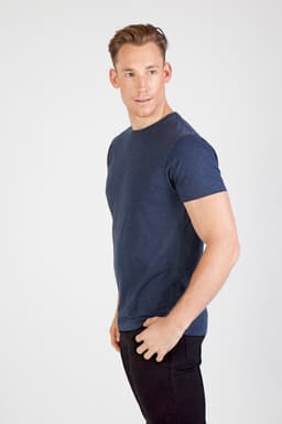 A fitted unisex marl crew neck t-shirt in navy, displayed on a model against a plain background.