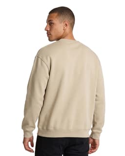 A model wearing a lavender-coloured poly cotton fleece sloppy joe sweater, paired with black pants.