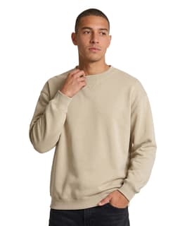 A woman wearing a light purple poly cotton fleece jumper with a relaxed fit. The jumper features a logo.