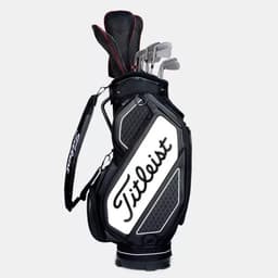 A black and white midsize golf staff bag with multiple clubs and a logo. It features a padded shoulder strap.