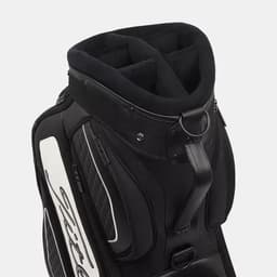 A black midsize staff bag with multiple compartments and a branded logo. It features a padded top and sturdy handles.