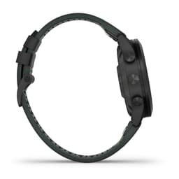 A watch in black and green tones with a textured strap and multi-function buttons on the side. Features branding.