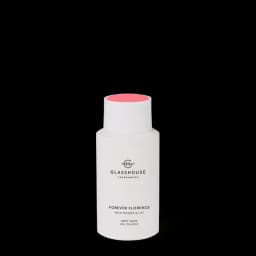 A white bottle of body wash titled "Forever Florence" with a floral scent, accompanied by a logo.