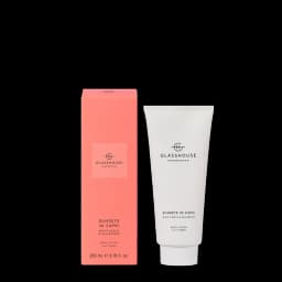 A white body lotion tube with a pink box, both labelled "Sunsets in Capri" with a peach scent.