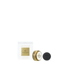 A car diffuser set featuring a gold casing with a black refill disc. The box is white with a gold logo.
