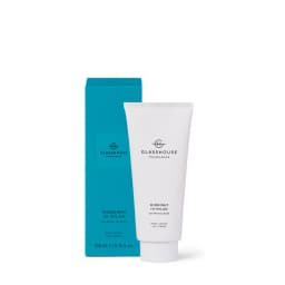 A white body lotion tube with a blue box, titled "Midnight in Milan," featuring saffron and rose. It has a logo.
