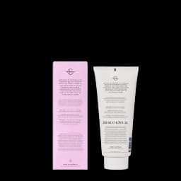 A body lotion in a cream tube with a pink and white design, featuring a logo and containing 200ml.