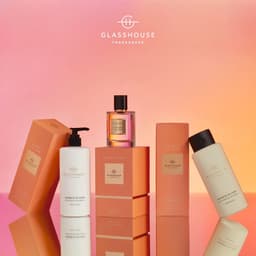 A collection of Glasshouse Sunsets in Capri Eau de Parfum and scented body products, featuring peach and sea breeze notes.