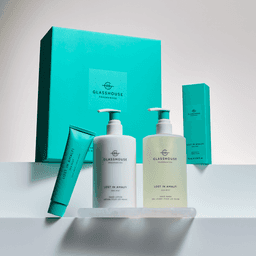 A set of hand wash, hand lotion, and tray in a turquoise box, featuring a pale green and white design.