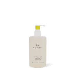 A hand wash bottle in cream with a yellow pump, labelled Montego Bay Rhythm, featuring a brand logo. 