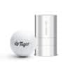 A white golf ball next to a cylindrical stamp in a silver casing, featuring a logo on the ball.
