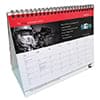 A5 wiro bound tent calendar featuring a red and white design with a spiral binding. Includes a graphic and a logo.