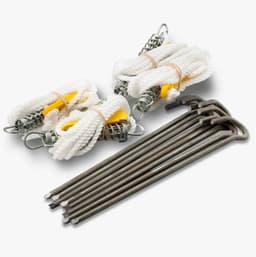Heavy-duty metal pegs and spring-loaded guy ropes in white and silver, with some pegs arranged neatly.