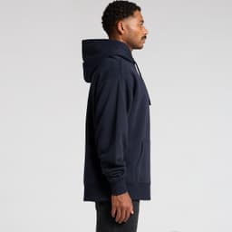 A navy blue heavy hoodie featuring a kangaroo pocket and an adjustable hood, displayed on a model from the side.