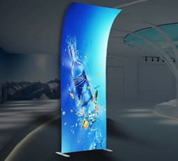 A tension fabric display featuring a vibrant blue design with a water bottle and splashes, set in a modern indoor space.