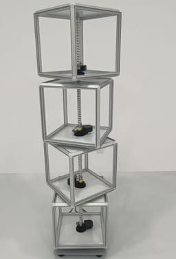 A rotating light box with transparent compartments, featuring a silver frame and black bases, designed for exhibitions and events.