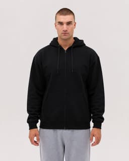 A black zip hoodie with a front pocket and a drawstring hood, modelled by a person against a neutral background.