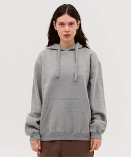 A grey hoodie with a drawstring hood and a front pocket, featuring a logo.