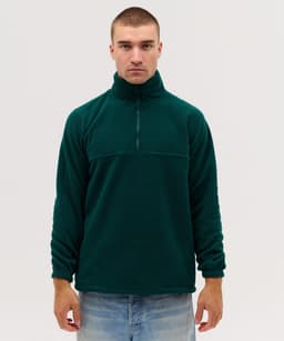 A dark green polar fleece 1/4 zip jacket with a high collar and elasticated cuffs, worn by a model.