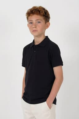 A black youth polo shirt worn by a child with curly hair, featuring a logo on the chest.