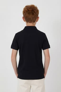 A youth polo shirt in navy, featuring a collar and short sleeves. The back view shows a clean design with no visible branding.