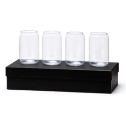 A set of four clear glass beer cans displayed on a black box. The glasses have a cylindrical shape.