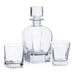A drink bottle and two matching glasses in clear glass, featuring a classic design with a stopper.