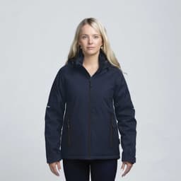 A woman wearing a navy soft shell jacket with a hood and zippered pockets, featuring a logo on the sleeve.